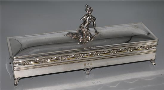 An Edwardian Art Nouveau plated casket surmounted with a figure of a seated lady, 14.25in